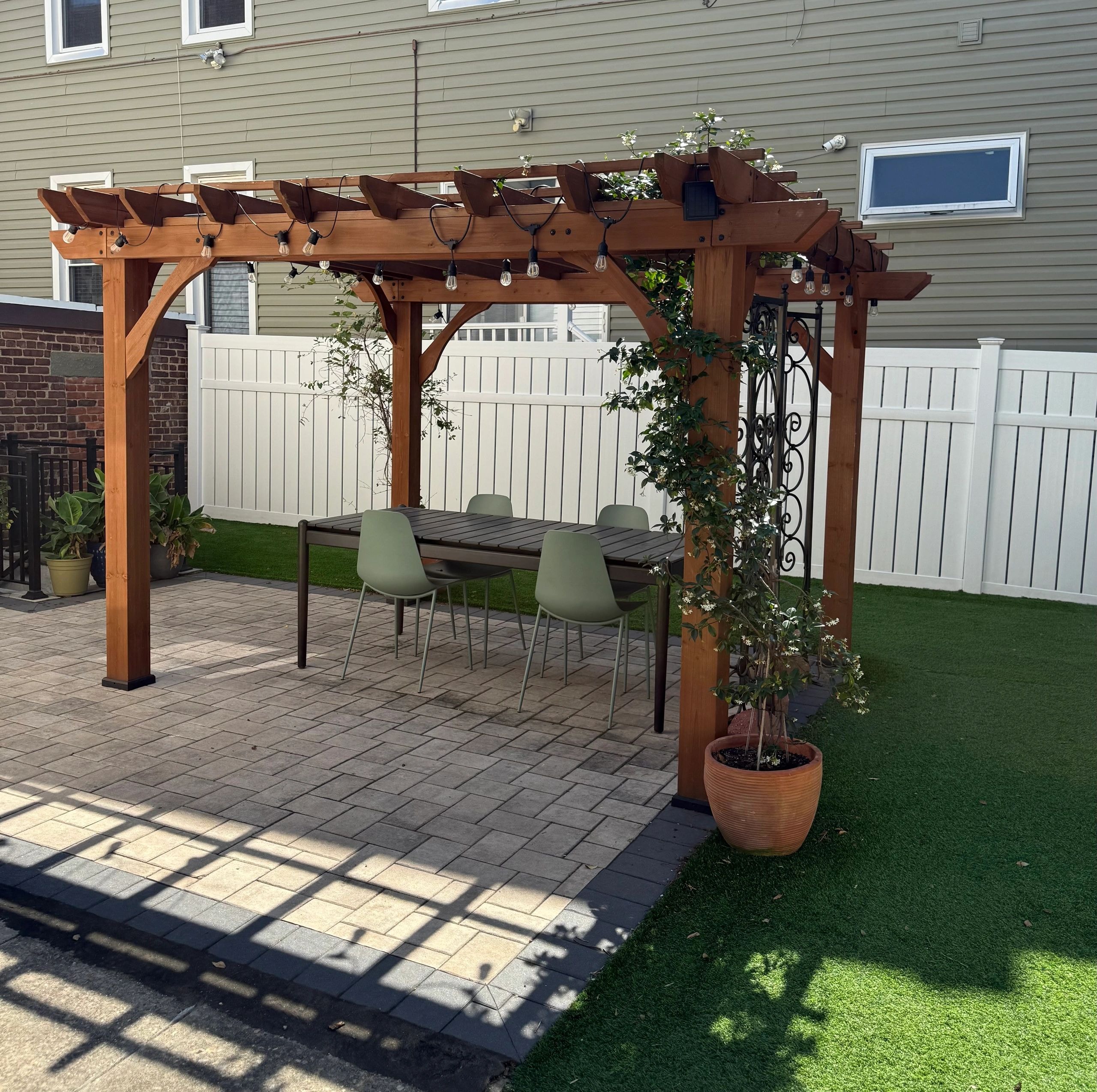 Pergola with string lights and outdoor dining — JKPOH Exterior Group Bergen County
