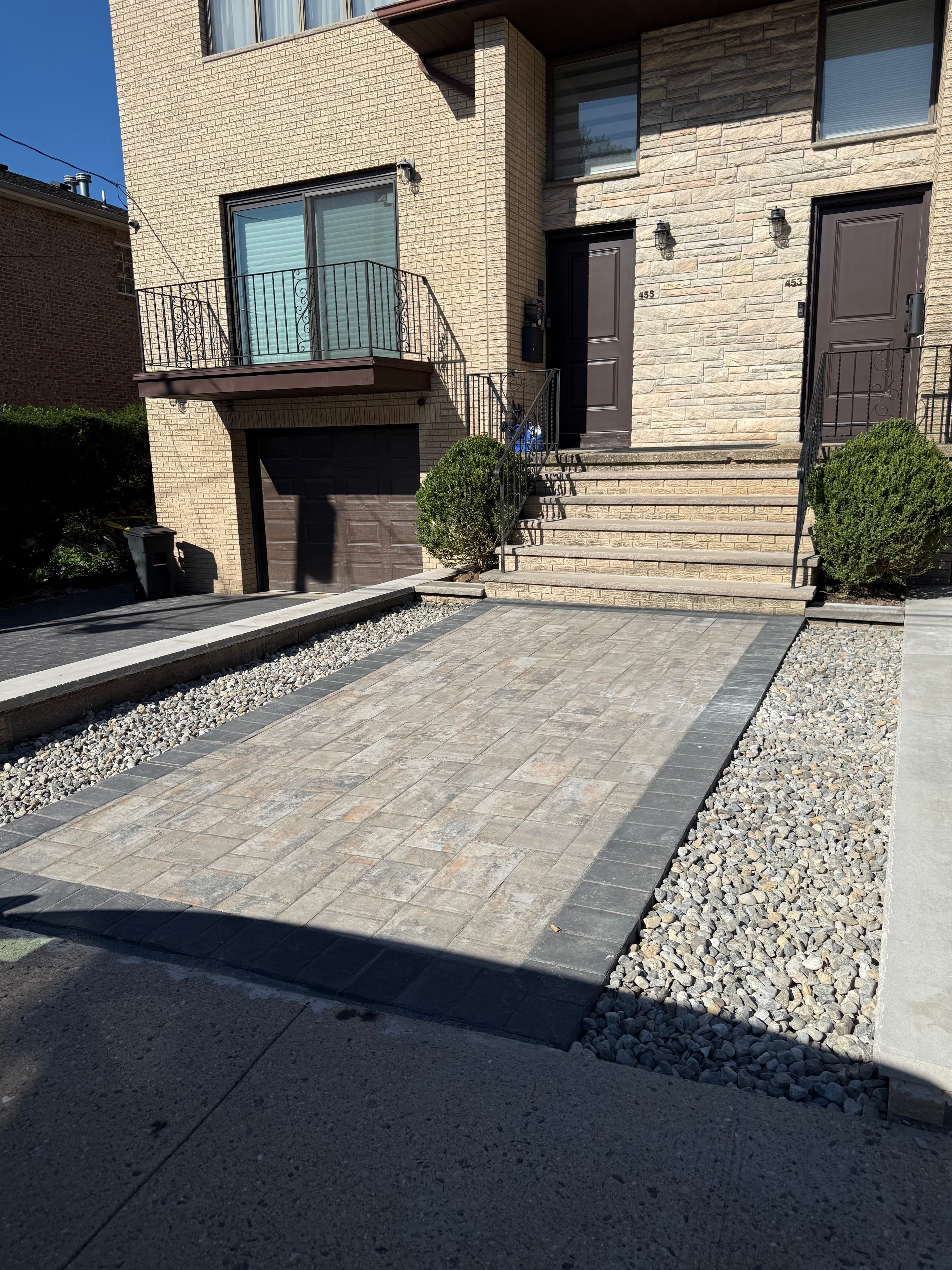 Completed residential paver driveway with retaining wall and decorative stone — Fort Lee, NJ