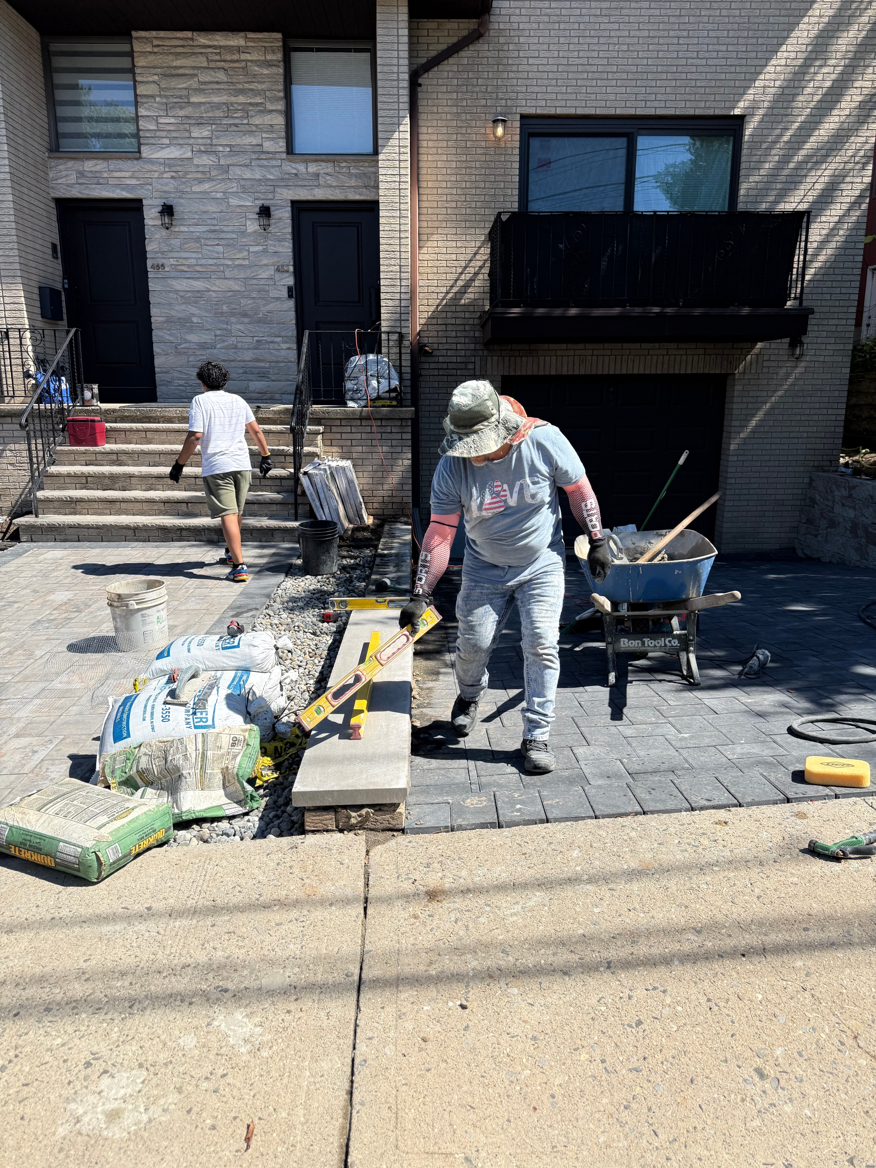Paver installation in progress — leveling and setting interlocking pavers on prepared base in Fort Lee, NJ